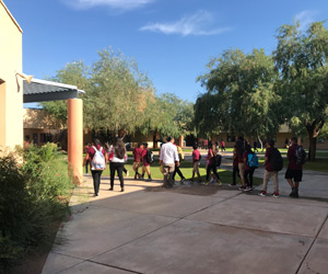 Students walking up to the school entrance